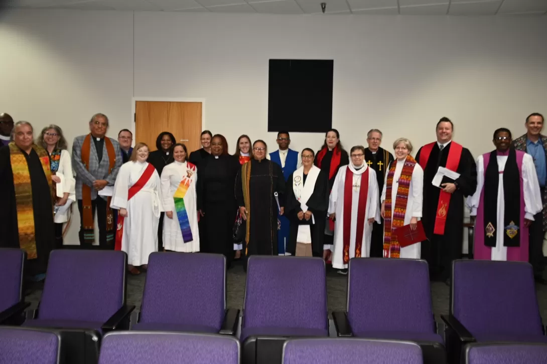 A variety of clergy in their vestments, many from MCC member denominations, pose for a photo.