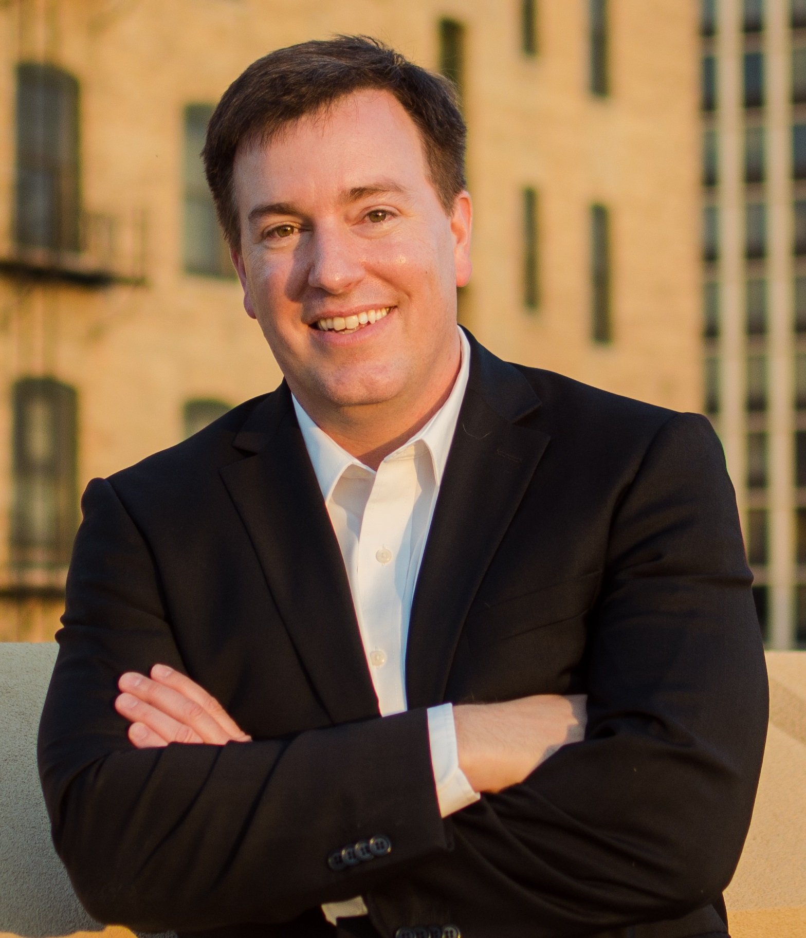 Photo of Dr. Michael O. Emerson leaning against a brick wall